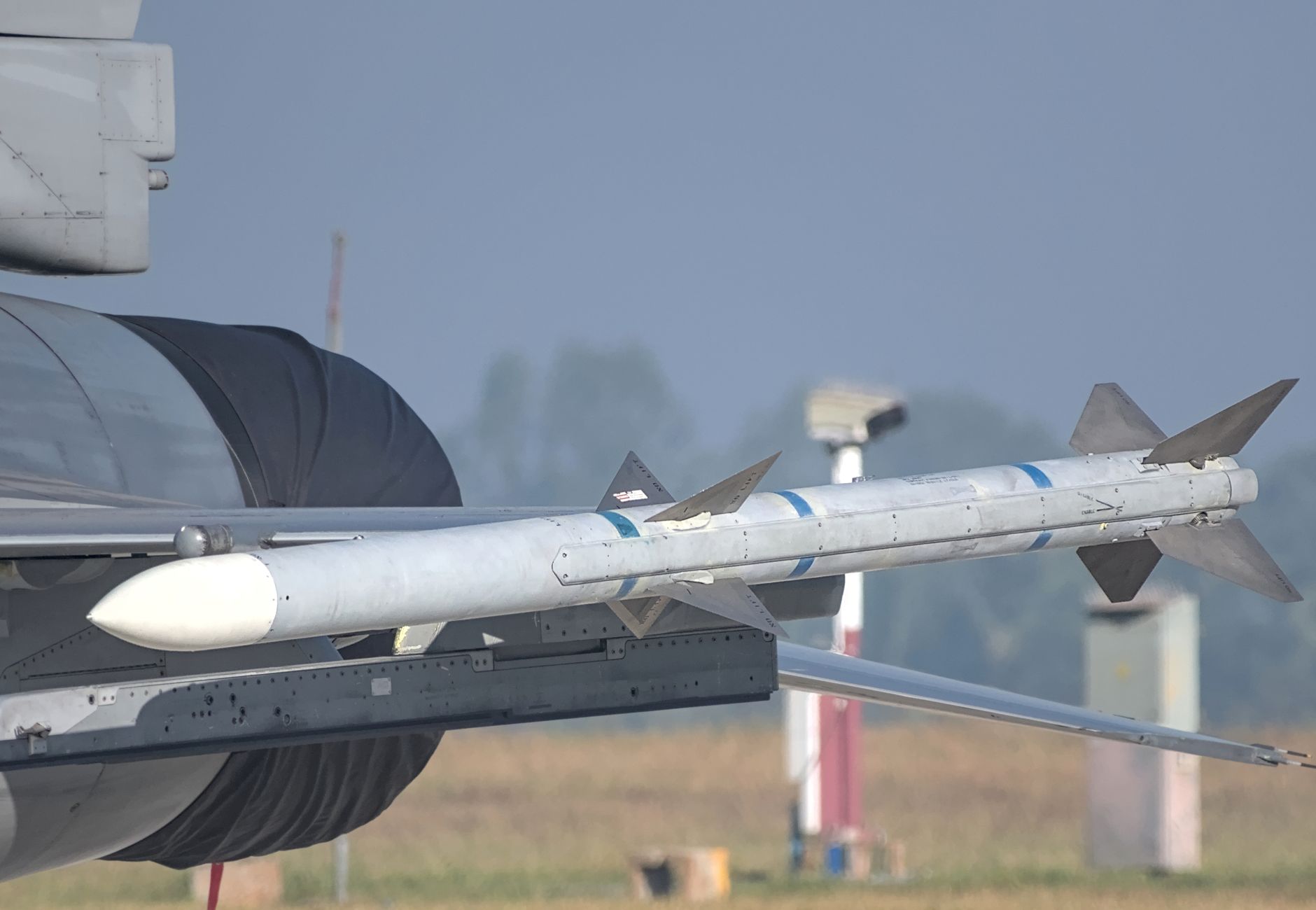 Close-up of a missile mounted on a military aircraft wing at an airshow in Bengaluru, India.