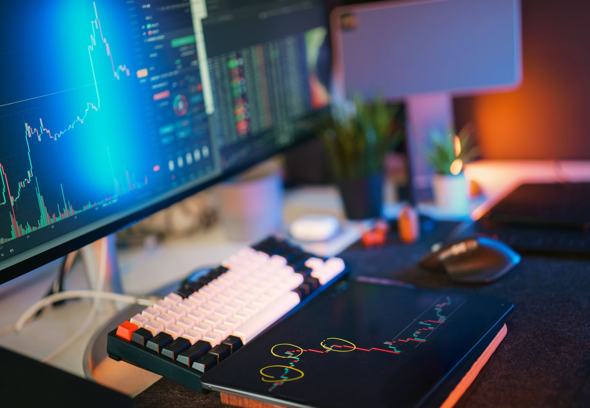 Modern workspace with screens displaying cryptocurrency market data and trends.