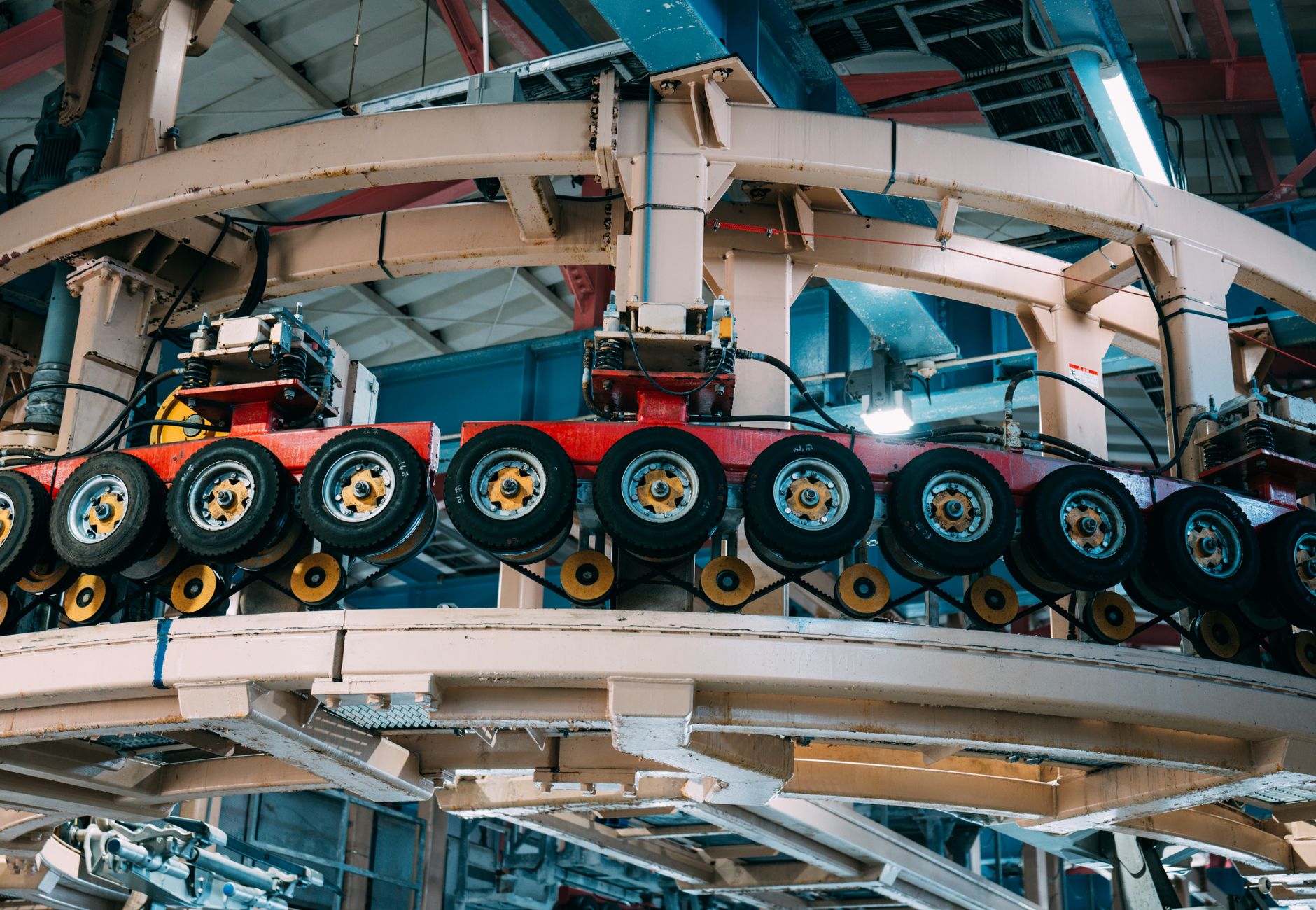 Close-up view of a complex industrial conveyor system inside a manufacturing facility.